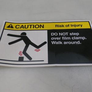 31006337 - LABEL CAUTION 'DO NOT STEP OVER FILM CLAMPS.'